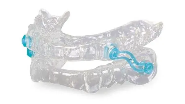 A clear custom mandibular advancement device for use during sleep