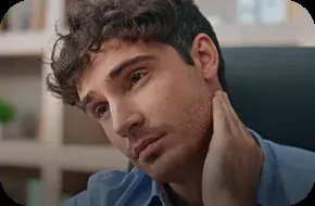 A person holding the side of the jaw in front of the ear, where temporomandibular pain is typically felt