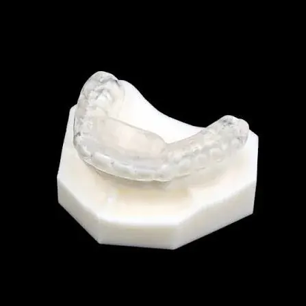 A clear acrylic occlusal splint on a dental study model